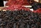 Heap of dried Ancho chile peppers on counter at market