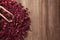 Heap of dry hibiscus tea with scoop on wooden background