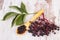 Heap of elderberry with wooden spoon on old wooden background, healthy food