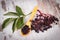 Heap of elderberry with wooden spoon on old wooden background, healthy food