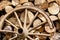 Heap of firewood and old broken wheel