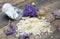 Heap of flakes of soap with essential oil and  lavender flowers and sodium bicarbonate on wooden background