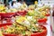 Heap of fragrant flowers with incense on red wooden trays for worship the Buddha