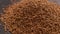 heap of freeze-dried instant coffee granules slow spinning loopable close-up view
