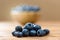 Heap of fresh blueberries lying on wooden table.