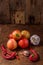 Heap of fresh organic seasonal vegetables on wooden background, copy space. Unripe tomatoes, garlic, hot pepper. Farm vegan