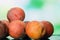 Heap of fresh peaches on natural green background. Summer harvest of peaches. Fruits background.