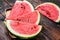 Heap of fresh red sliced watermelon. Dark Wooden background. Top view