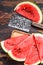 Heap of fresh red sliced watermelon. Dark Wooden background. Top view