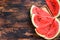 Heap of fresh red sliced watermelon. Dark Wooden background. Top view. Copy space