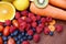 Heap of fresh tropical fruits colorful vegetables summer healthy food / Many ripe fruit mixed on wooden background