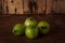 Heap of fresh unripe green tomatoes on brown wooden kitchen table. Local farmer fresh organic product. Vegan eco-friendly no