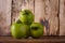 Heap of fresh unripe green tomatoes on brown wooden kitchen table. Local farmer fresh organic product. Vegan eco-friendly no