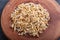 Heap of germinated wheat on brown wooden background, top view