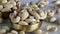 A heap of golden roasted cashews in a brass bowl