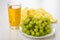 Heap of grapes in plate, napkin, glass of grape juice