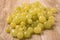 Heap of green grapes on wooden background,