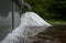 Heap of hail balls under rain gutter after heavy storm in a garden