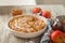 Heap of homemade apple pie close-up and copy space. A quick autumn dessert idea with tea. Autumn pie with apples, Rustic wooden ba