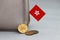 Heap of Hong Kong dollar coin money and mini Hong Kong flag with the leather wallet on grey background