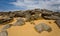 Heap of huge stones lie on a sand