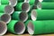Heap of many colorful green cardboard rolls