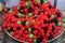 Heap of mixed pieces of Turkish candy jelly sweets with red fruits flavours and sugar, in display on a table at a street food mark