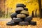 heap of obsolete wheels, old car tires decorated with bright yellow leaves on the road in the autumn forest