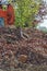 Heap of old bricks and hydraulic bulldozer excavator arm in background