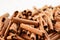 Heap of organic cinnamon bark, close up selective focus photo - only few sticks in focus