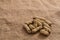 Heap of peanuts on burlap surface background