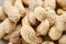 Heap of peanuts on light tablecloth, close-up, shallow depth of field, selective focus, macro