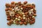 Heap Of Peeled Almonds, Hazelnuts, Cashew And Walnuts on a white surface top view stock photo