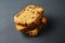 Heap of pieces of tasty sweet homemade bread with raisin lies on dark concrete table on kitchen