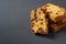 Heap of pieces of tasty sweet homemade bread with raisin lies on dark concrete table on kitchen