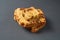 Heap of pieces of tasty sweet homemade bread with raisin lies on dark concrete table on kitchen