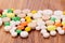 Heap of pills on wooden desk