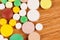 Heap of pills on wooden desk