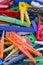 Heap of plastic laundry clothespin in vivid colors