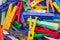 Heap of plastic laundry clothespin in vivid colors