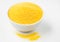 Heap of Polenta or Cornmeal Flour in a white bowl. Ground Dried Corn or Corn Grits. Top View, Copy Space.