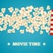 Heap popcorn for movie lies on blue background.