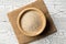 Heap of psyllium husk also called isabgol in wooden bowl on white table background flat lay from above