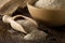 Heap of psyllium husk also called isabgol in wooden scoop and bowl on table