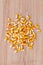 Heap of raw corns seeds, maize or sweetcorn kernels top view on wooden background.