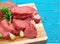 Heap of raw meat with garlic on cutting board