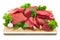 Heap of raw meat with garlic and lettuce on wooden