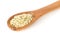 Heap of raw, organic hemp seeds on wooden spoon over white