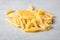 Heap raw penne pasta on ultimate gray background