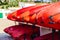 Heap of red kayaks on a beach